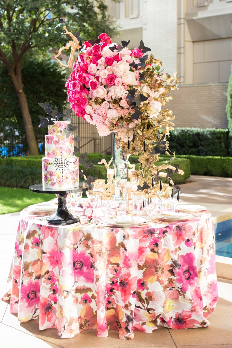 Floral Tablescape with White and Pink Cake and Centerpiece
Photography: Thisbe Grace Photography
Read More:
http://www.insideweddings.com/weddings/dramatic-wedding-shoot-inspired-by-alexander-mcqueen-chanel/749/ white cake with pink flower design and black jewels black butterflies floral linen rose centerpiece