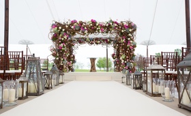 Magical Lantern-Lit Aisle with Flowery Chuppah
Photography: Sheri Whitko
Read More:
http://www.insideweddings.com/weddings/jewish-wedding-with-personal-details-and-a-whimsical-garden-motif/808/ Chuppah with pink flowers branches greenery, Lanterns, tented venue, Jewish ceremony