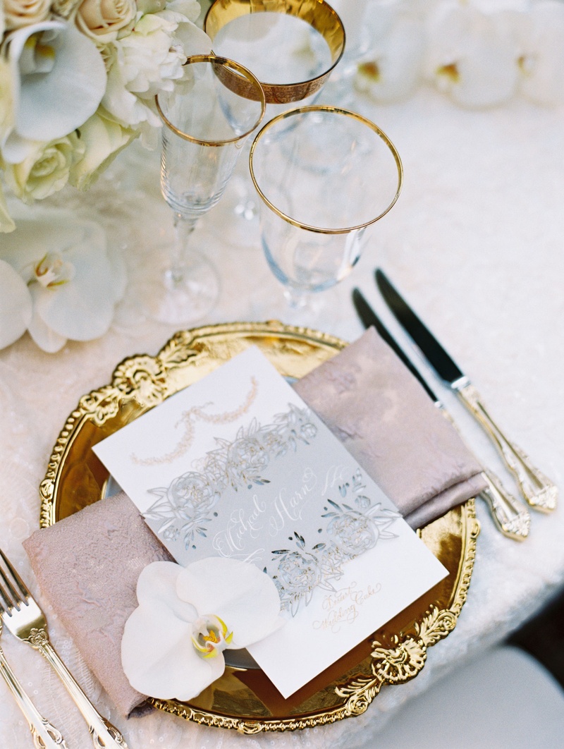 Ornate Menu with Personalized Belly Band
Photography: Abby Jiu Photography
Read More:
http://www.insideweddings.com/weddings/chic-parisian-romance-inspired-spring-wedding-in-washington-dc/1038/ Wedding reception gold charger pink napkin menu card orchid silver grey belly band with calligraphy