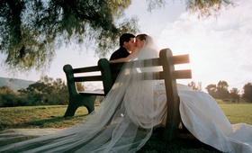Couple Kissing on Park Bench
Photography: Yvette Roman Photography
Read More:
http://www.insideweddings.com/weddings/autumn-inspired-wedding-in-ojai-valley-california/217/ bride and groom kiss seated on park bench