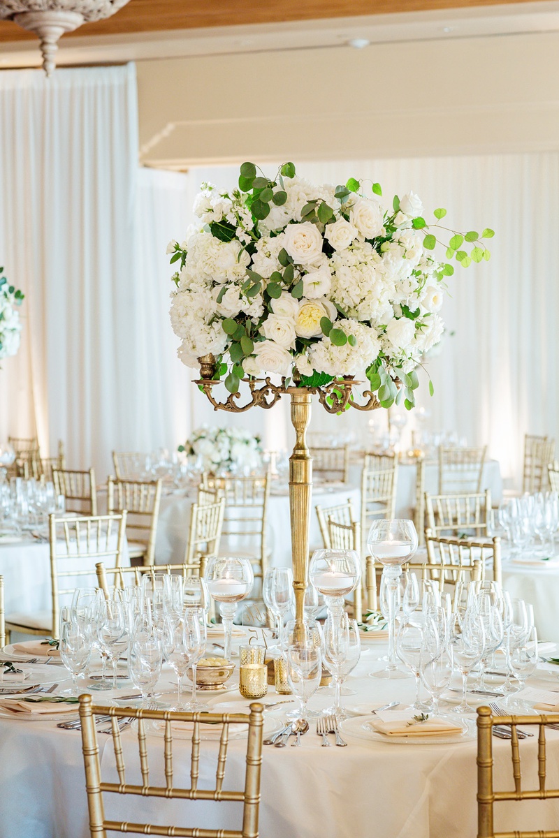 Fresh Florals on Gold Stand
Photography: Chard Photo
Read More:
http://www.insideweddings.com/weddings/alfresco-ceremony-on-the-coast-classic-ballroom-reception/1290/ white roses and eucalyptus leaves on thin gold stand
