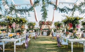 Whimsical, Colorful Tent Reception
Photography: Scott Clark Photo
Read More:
http://www.insideweddings.com/weddings/whimsical-outdoor-destination-wedding-at-a-ranch-in-california/1378/ wedding reception in clear top tent greenery drapery white table gold purple chairs colorful flowers