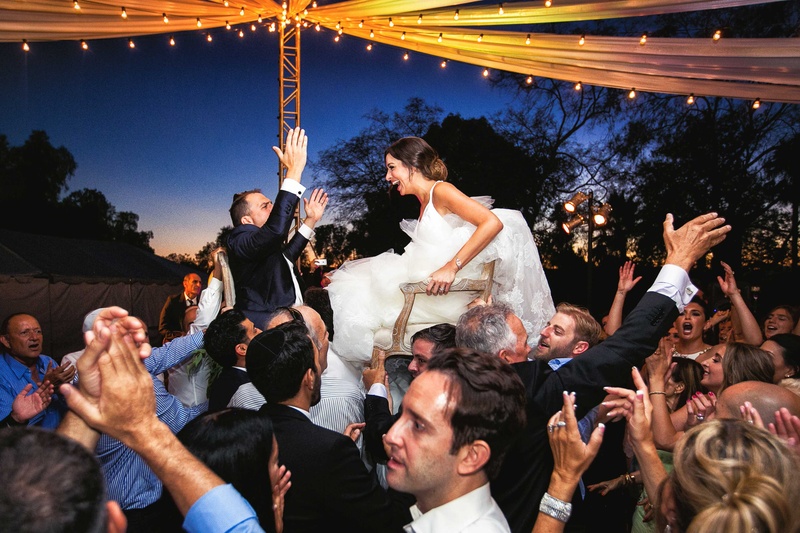 Couple Lifted in Chairs by Guests
Photography: Callaway Gable
Read More:
http://www.insideweddings.com/weddings/alfresco-summer-wedding-with-lush-foliage-accents-in-california/805/ a newlywed couple lifted up in two different chairs by the guests at their reception