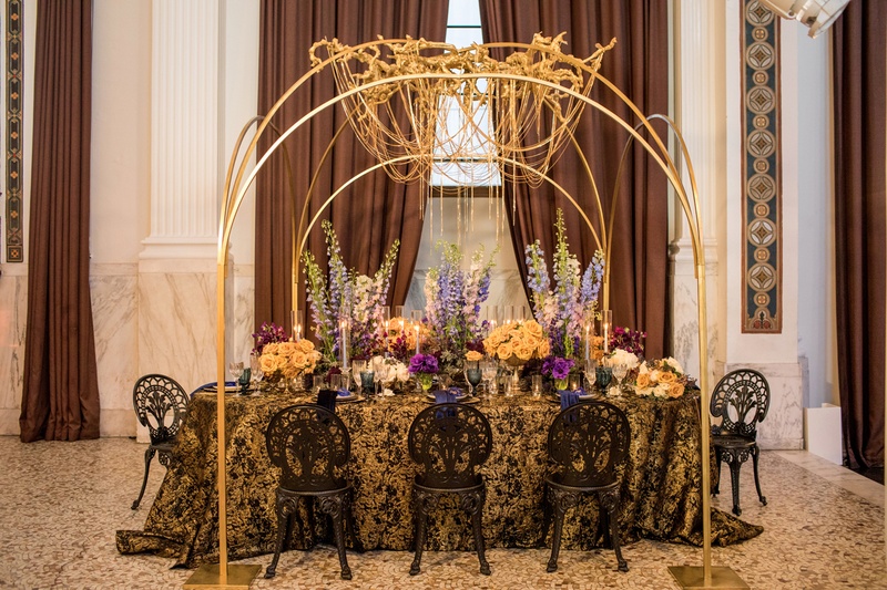 Golden Chain Chandelier
Photography: Duke Photography
Read More:
http://www.insideweddings.com/weddings/dramatic-tablescape-at-launch-party-for-luxe-linens-newest-line/987/ wedding styled shoot, gold chain chandelier, blue delphiniums, black and gold