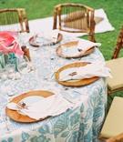 Hawaii-Inspired Table Décor
Photography: Steve Steinhardt
Read More:
http://www.insideweddings.com/weddings/tropical-romantic-destination-wedding-in-hawaii/397/ Hawaiian floral linens and wood charger plates