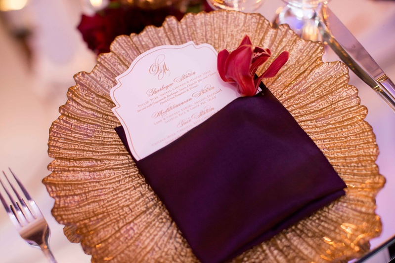 Die-Cut Menu Inside Purple Linen Napkin
Photography: KLK Photography
Read More:
http://www.insideweddings.com/weddings/greek-orthodox-church-ceremony-glamorous-purple-gold-reception/730/ Gold texture charger plate on mirror table with die-cut wedding dinner menu inside purple napkin
