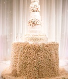 Fresh Rose Table for Wedding Cake
Photography: Samuel Lippke Studios
Read More:
http://www.insideweddings.com/weddings/romantic-jewish-wedding-with-lush-ivory-flowers-rose-gold-details/790/ Tall white wedding cake with sugar flower tiers on top of blush pink rose tablecloth table design