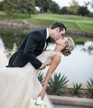 Groom Kisses Bride After Dip
Photography: Samuel Lippke Studios
Read More:
http://www.insideweddings.com/weddings/elegant-alfresco-ceremony-ballroom-reception-in-dallas-texas/930/ Groom in tuxedo with bow tie kisses bride in champagne Monique Lhuillier wedding dress