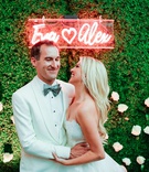 Couple with Neon Sign
Photography: Jana Williams Photography
Read More:
http://www.insideweddings.com/weddings/classically-elegant-alfresco-ceremony-ballroom-reception-in-ojai/1320/ groom in white tuxedo hugging bride in strapless dress underneath neon sign with names on boxwood