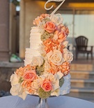 Ruffle Cake with Cascading Fresh Flowers
Photography: Fusion Estudio
Read More:
http://www.insideweddings.com/weddings/destination-wedding-with-coral-ivory-grey-color-scheme-in-mexico/766/ White three layer wedding cake with fresh orange and white rose flowers, rhinestone monogram topper
