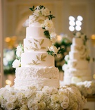Tall Cake with Gold Leaves %26 Ruffles
Photography: K. Thompson Photography
Read More:
http://www.insideweddings.com/weddings/traditional-ceremony-ballroom-reception-with-blue-gold-decor/1201/ wedding cake white with ruffles flower layers gold leaves fresh roses greenery