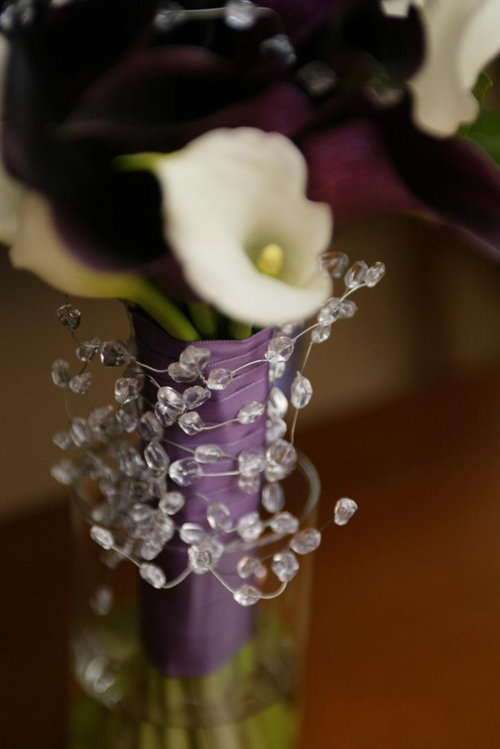 Crystal-Wrapped Bouquet
Photography: Lyn Sims Photographer
Read More:
http://www.insideweddings.com/weddings/glamorous-fall-wedding-with-garden-touches-in-tucson-arizona/258/ Calla lilies tied with purple ribbon and crystals