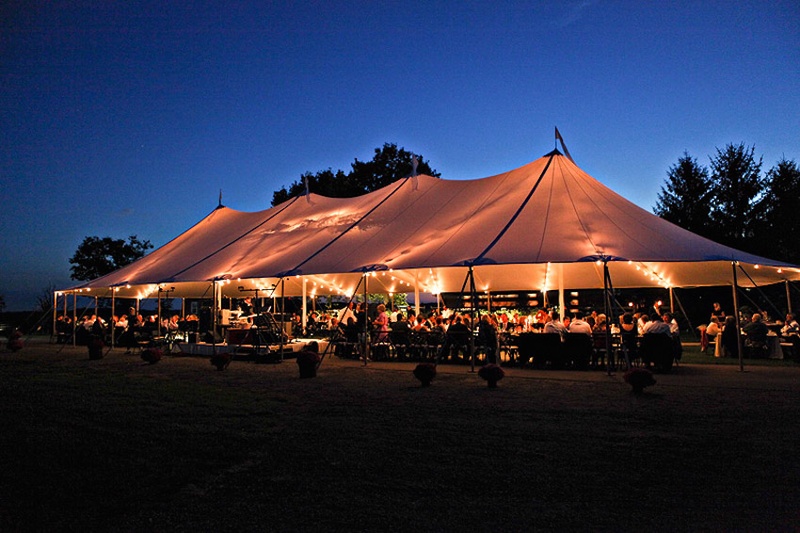 Tented Reception at Dusk
Photography: Stacy Newgent
Read More:
http://www.insideweddings.com/weddings/rustic-barn-wedding-tented-reception-on-family-farm-in-ohio/690/ Farm wedding reception in an open-sided tent lit by market lights at sunset