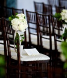 Posies of Ivory Roses on Chairs
Photography: Beale %26 Wittig
Read More:
http://www.insideweddings.com/weddings/luxurious-rustic-wedding-at-lakeside-country-club-in-wisconsin/721/ Wedding ceremony with dark chiavari chairs, white cushions, white roses, greenery, white ribbons