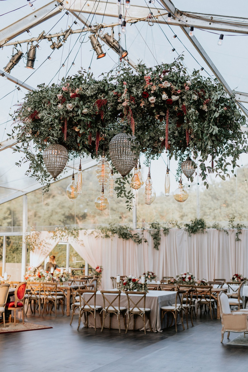 Tented Wedding with Large Floral Installation
Photography: Grant Daniels Photography
Read More:
http://www.insideweddings.com/weddings/outdoor-ceremony-tented-reception-with-cozy-fall-color-palette/1183/ wedding reception tent wedding flower chandelier edison lightbulb vineyard chairs rustic decor