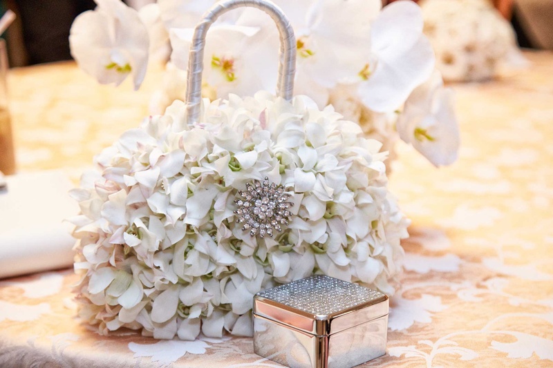 Charming Floral Purse
Photography: KingenSmith
Read More:
http://www.insideweddings.com/weddings/delicately-detailed-chicago-wedding-with-jewish-christian-customs/762/ white floral purse with silver metallic box on white table linens