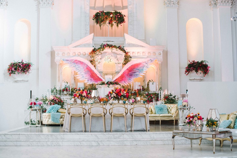 Reception Tablescape Featuring Painted Wings
Photography: Krista Mason Photography
Read More:
http://www.insideweddings.com/weddings/mediterranean-inspired-styled-shoot-featuring-unique-details/856/ reception tablescape pink purple blue gold wings white lounge area