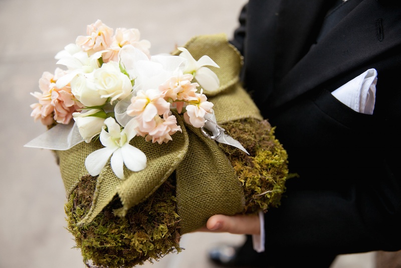 Moss %26 Burlap Ring Pillow
Photography: Michael Carr Photography
Read More:
http://www.insideweddings.com/weddings/traditional-church-ceremony-forest-inspired-reception-in-houston/695/ Ring bearer holds moss ring pillow with green burlap and white pink flowers
