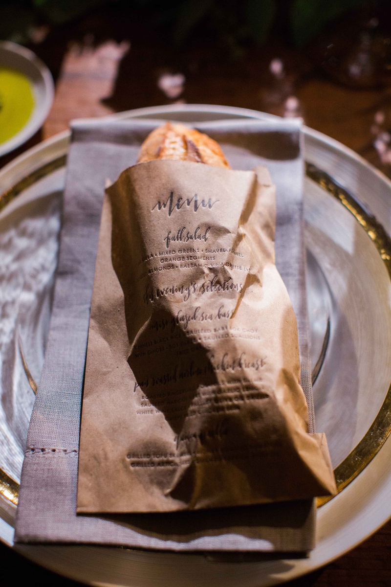 Baguette in Kraft Paper Menu Bag
Photography: Gabe Aceves Photography
Read More:
http://www.insideweddings.com/weddings/warm-cozy-wedding-at-unique-warehouse-venue-in-washington-dc/902/ Baguette of bread in kraft paper letterpress menu bag at wedding reception