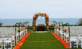 Oceanfront Ceremony Décor
Photography: TripleCord Photography
Read More:
http://www.insideweddings.com/weddings/beachside-summer-wedding-at-the-montage-laguna-beach/287/ Orange floral arch and petal-lined aisle