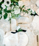 White, Navy %26 Greenery Place Setting
Photography: Jennings King Photography
Read More:
http://www.insideweddings.com/weddings/alfresco-spring-destination-wedding-in-charleston-south-carolina/1277/ wedding reception place setting glass charger circle menu blue script velvet navy ribbon napkin