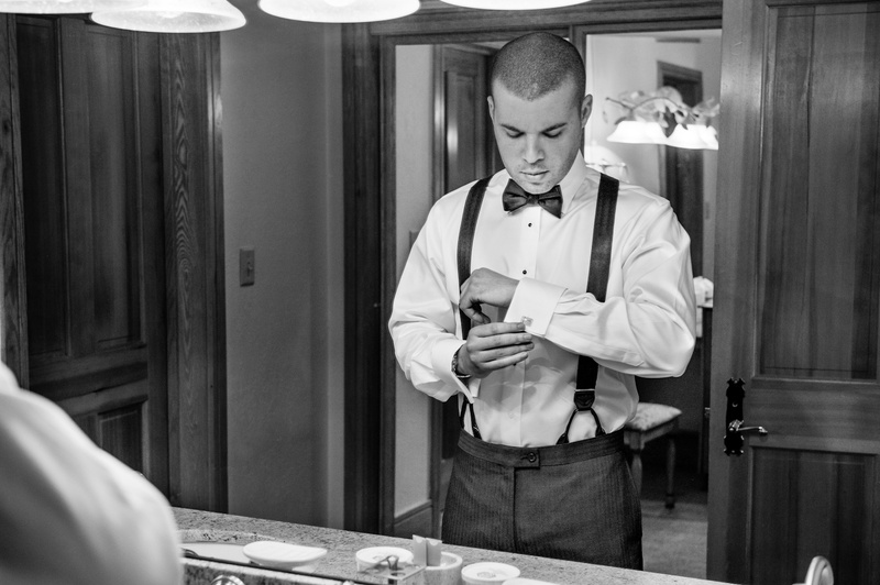 Groom Getting Ready
Photography: Handeland Tesoro Photography
Read More:
http://www.insideweddings.com/weddings/snowy-outdoor-winter-ceremony-cozy-lodge-reception/522/ Black and white photo of man in suspenders
