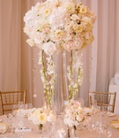 Cascading Orchids and Crystals
Photography: Brian Leahy Photography
Read More:
http://www.insideweddings.com/weddings/a-classic-romantic-celebration-with-lush-florals-in-beverly-hills/973/ tall, flurry centerpiece of ivory blossoms with cascading crystals and orchids