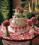 Whimsical Wedding Cake
Photography: Lawrence Crandall Photography
Read More:
http://www.insideweddings.com/weddings/alice-in-wonderland-queen-of-hearts-themed-wedding/83/ Unique wedding cake on table covered with rose petals
