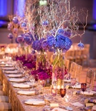 Purple Centerpieces with Gold Linens
Photography: Premack Weddings
Read More:
http://www.insideweddings.com/weddings/dual-ceremony-with-indian-and-western-traditions/758/ violet hydrangeas in glass column vases with branches and glass orbs. sequinned patterned linens