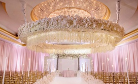 Glamorous, Opulent Wedding Ceremony
Photography: Milanés Photography
Read More:
http://www.insideweddings.com/weddings/opulent-ballroom-wedding-with-coral-gold-color-palette-in-atlanta/1240/ wedding ceremony circle flower ceiling arrangement gold chairs pink lighting drapery white flowers
