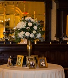 Floral Arrangement with Family Pictures
Photography: Green Vintage Photography
Read More:
http://www.insideweddings.com/weddings/modern-country-club-wedding-with-baseball-inspired-details/1043/ wedding table with family wedding portraits, floral arrangement in gold stand with ivory flowers