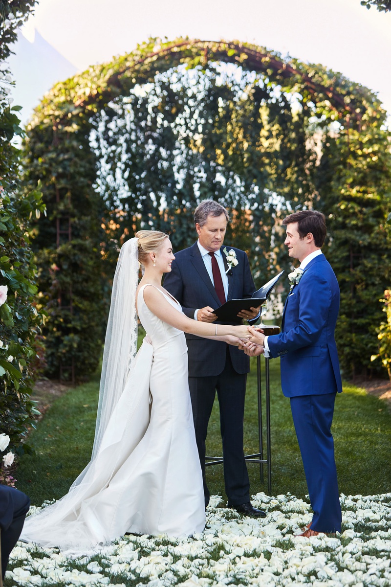 Bride %26 Groom Under Arch with Officiant
Photography: Christian Oth Studio
Read More:
http://www.insideweddings.com/weddings/timeless-wedding-with-garden-inspired-decor-in-the-hamptons/1237/ wedding ceremony outdoor white flower petal aisle greenery arch bride in updo veil groom blue suit