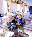 Cocktail Hour Floral Arrangement
Photography: Lauren Ross Photography %26 Nancy Cohn Photography
Read More:
http://www.insideweddings.com/weddings/sophisticated-breakers-wedding-with-pink-florals/335/ Pink, purple, and blue flowers in metallic vase on striped table