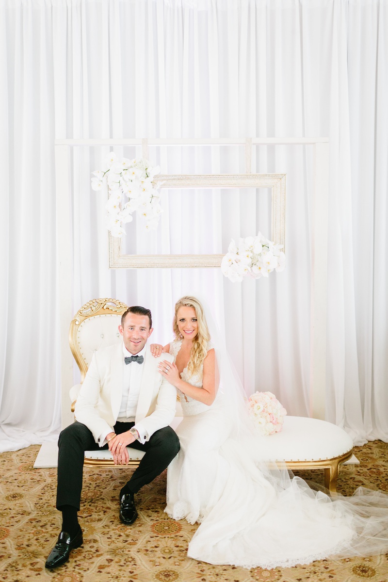 Newlyweds in Chic Lounge Area
Photography: Jodee Debes Photography
Read More:
http://www.insideweddings.com/weddings/elegant-alfresco-ceremony-reception-with-parisian-elements/1176/ bride in ines di santo gown, groom in white tuxedo jacket, gold and white chaise lounge with frames