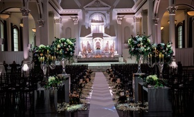 Non-Traditional Ceremony at Vibiana
Photography: Kim Fox Photography
Read More:
http://www.insideweddings.com/weddings/luxe-vintage-inspired-winter-wedding-in-downtown-los-angeles/1082/ Wedding ceremony at Vibiana altar lighting flower arrangements on risers petals along aisle runner