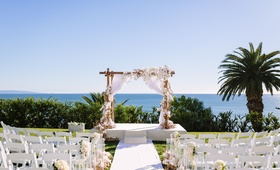 Beachy Arbor in Front of Ocean View
Photography: Brian Leahy Photography
Read More:
http://www.insideweddings.com/weddings/beachy-southern-california-ceremony-winter-wonderland-reception/877/ Wooden arbor with white fabric orchids and roses, ocean views bel-air bay club