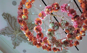 Ceiling Floral Sculpture
Photography: John Derryberry Photography
Read More:
http://www.insideweddings.com/weddings/glamorous-pink-ballroom-wedding-in-austin-texas/214/ pink and orange flower rings hung from ceiling