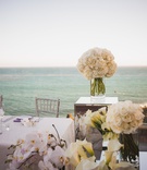 Oceanside Reception Dinner
Photography: Viera Photographics
Read More:
http://www.insideweddings.com/weddings/modern-style-seaside-wedding-with-geometric-detailing-in-malibu-ca/813/ White calla lilies and orchids around the bride and grooms seat at the reception.