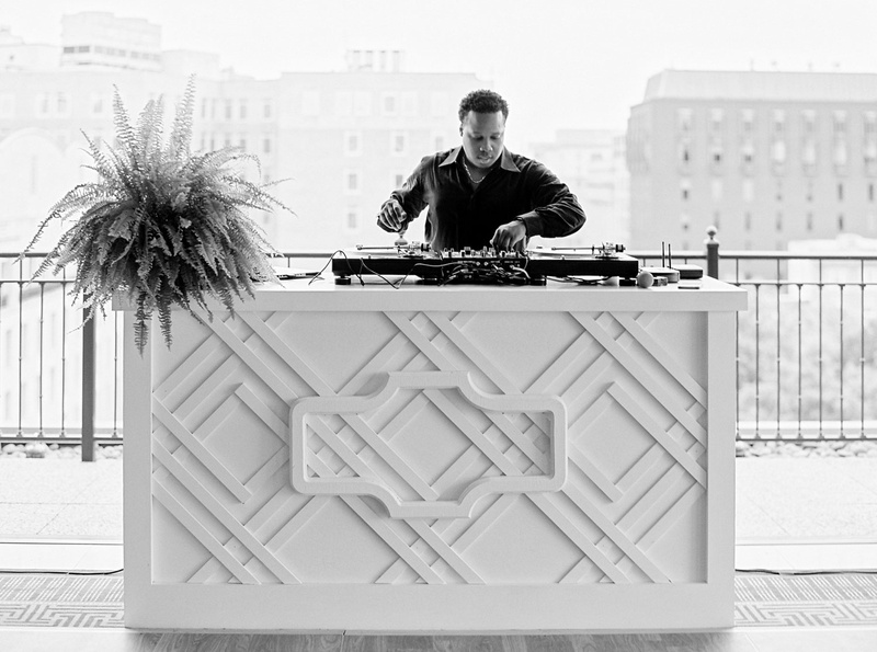 DJ in Washington, DC
Photography: Branco Prata
Read More:
http://www.insideweddings.com/weddings/chic-destination-wedding-with-california-style-in-washington-dc/1042/ Black and white photo of DJ with Washington dc buildings in background