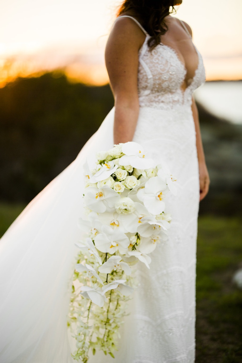Cascading Bouquet of White Orchids, Other Blooms
Photography: Joe Laurin Photography
Read More:
http://www.insideweddings.com/weddings/simple-chic-seaside-wedding-with-white-palette-in-rhode-island/953/ cascading bouquet white orchids other blooms roses greenery extended unique sophisticated