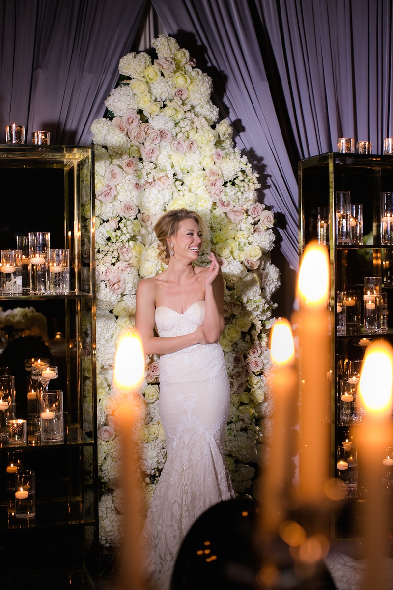 Jubilant Bride by Floral Panel at Reception
Photography: Gold Grid Studios
Read More:
http://www.insideweddings.com/weddings/celebratory-wedding-shoot-with-elegant-romantic-decor-in-chicago/728/ Bride in a fit-and-flare Inbal Dror dress in front of a panel of white hydrangeas, light yellow rose