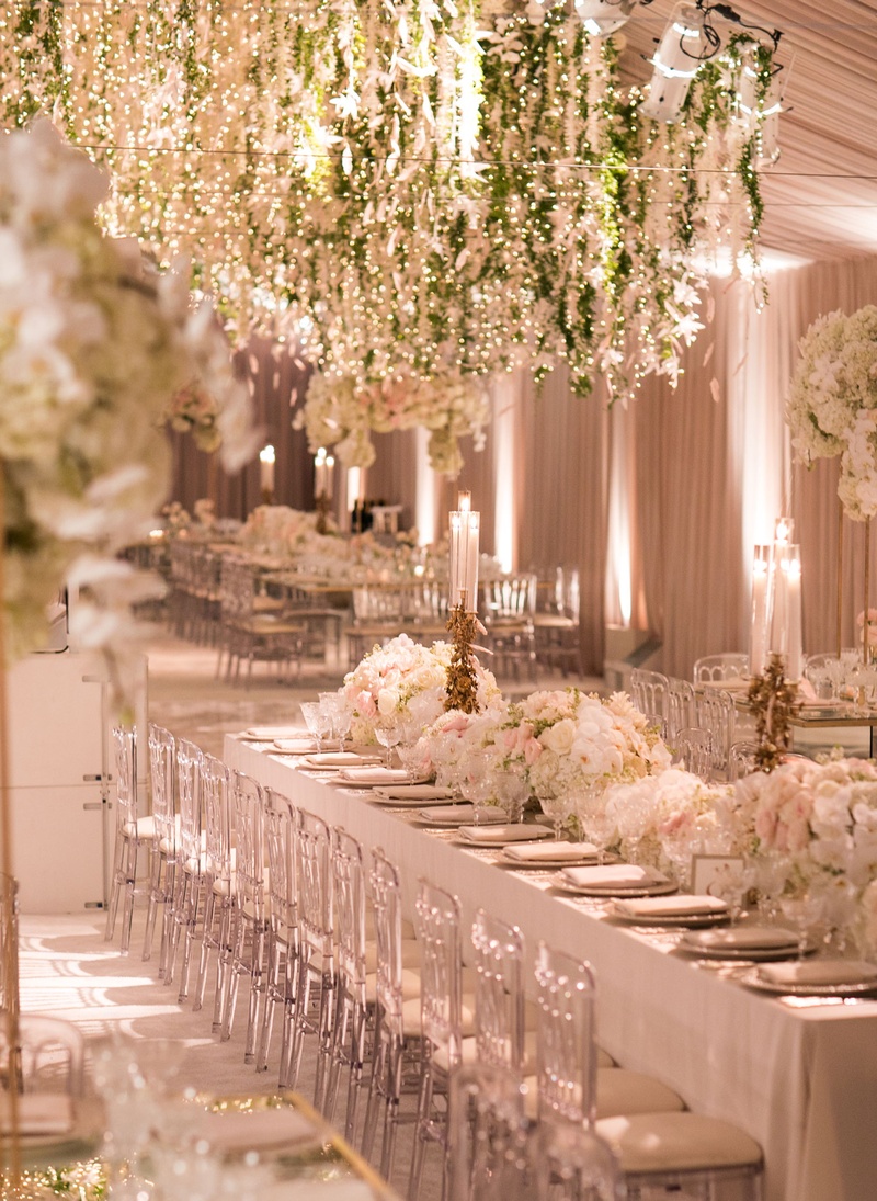 Floral Chandeliers in Blush Tent
Photography: Samuel Lippke Studios
Read More:
http://www.insideweddings.com/weddings/glamorous-alfresco-ceremony-ballroom-reception-and-after-party/1041/ Wedding reception blush tent long table clear chairs white flowers gold candleholders greenery over