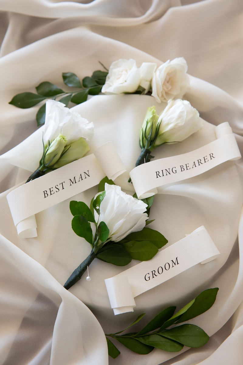 White Boutonnieres with Banners
Photography: Collin Pierson Photography
Read More:
http://www.insideweddings.com/weddings/beach-wedding-ceremony-romantic-reception-inspiration-in-cabo/1304/ wedding boutonniere flower white bloom greenery banner ribbon with groom best man ring bearer pins