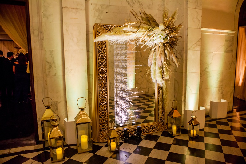 Mirror Seating Chart with Pampas Grass
Photography: Laura Grier of Beautiful Day Photography
Read More:
http://www.insideweddings.com/weddings/glamorous-art-deco-inspired-wedding-in-downtown-los-angeles/1162/ gold framed mirror seating chart with pampas grass on the corner, lanterns