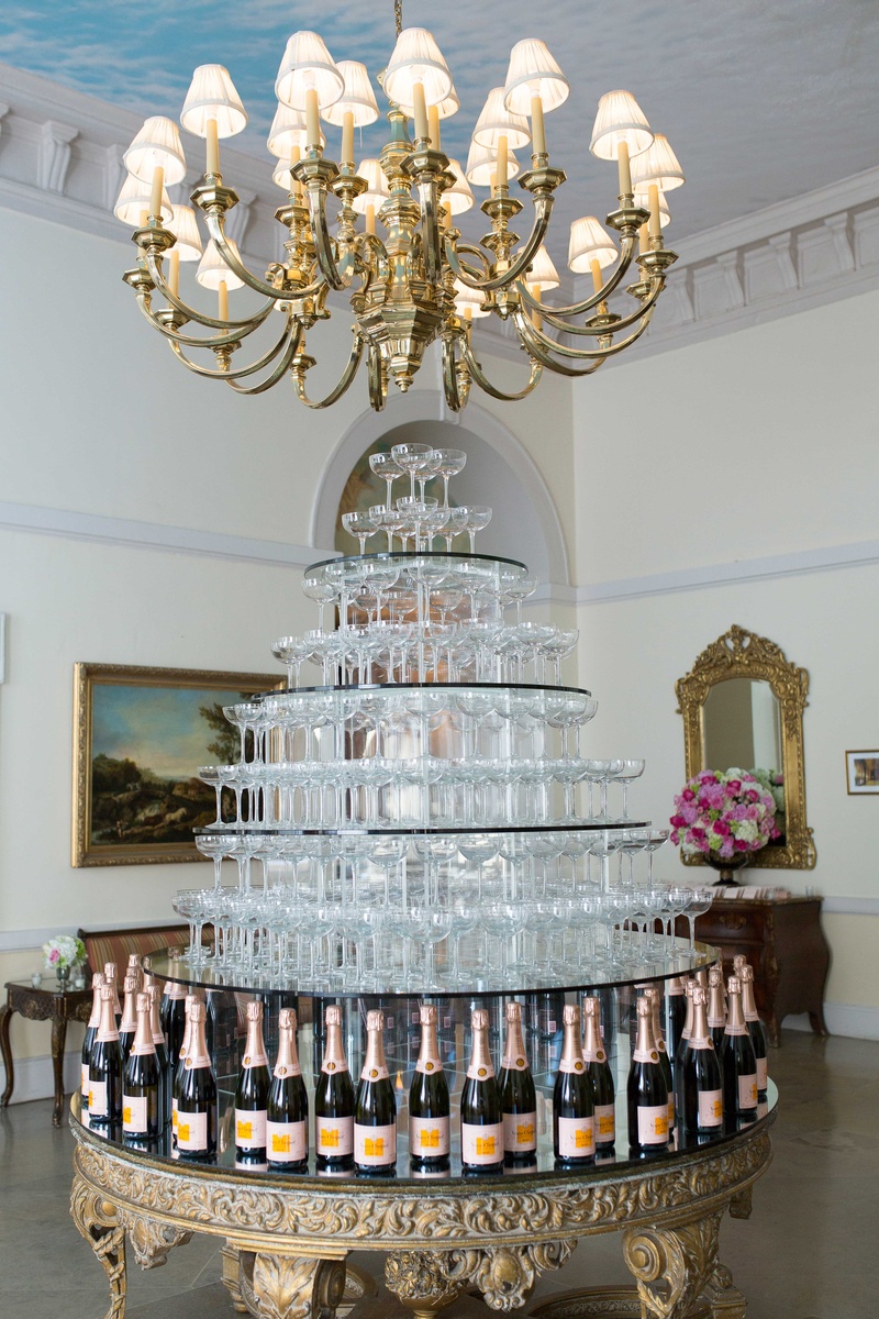 Champagne Glass Tower at Oheka Castle
Photography: Brett Matthews Photography
Read More:
http://www.insideweddings.com/weddings/regal-outdoor-ceremony-ballroom-reception-at-oheka-castle-in-ny/821/ Gold ornate table with champagne bottles holding up tiers of coupe champagne glasses in tower