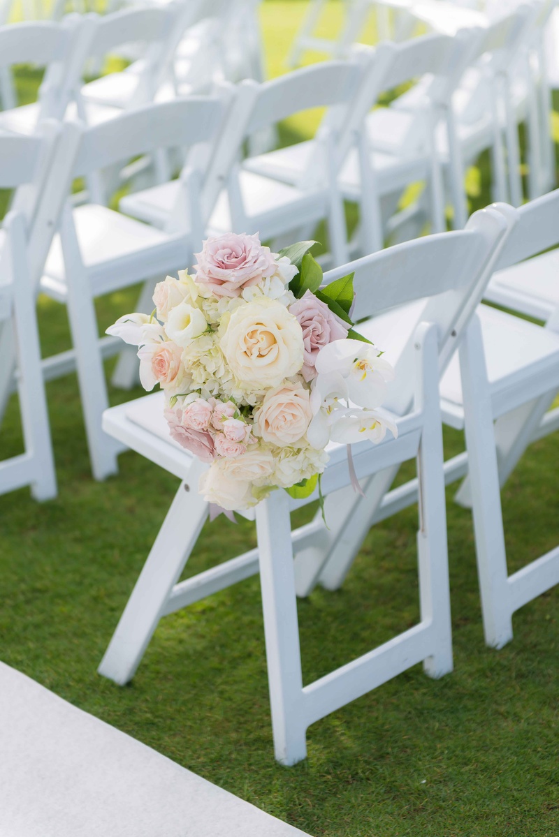 White Ceremony Chair with Flowers
Photography: The Yodsukars
Read More:
http://www.insideweddings.com/weddings/glam-10th-wedding-anniversary-party-vow-renewal-in-california/917/ White ceremony chair on grass lawn with white and pink rose, orchid, hydrangea flower arrangement
