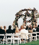 Oceanfront Wedding Ceremony
Photography: Glen Anthony Photography
Read More:
http://www.insideweddings.com/weddings/seaside-wedding-in-orange-county-california/608/ Red and white flowers on wrought-iron canopy