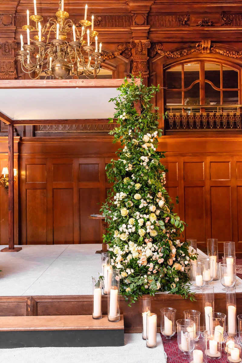 Greenery Climbing Up Chuppah
Photography: Mantas Kubilinskas Photography
Read More:
http://www.insideweddings.com/weddings/sophisticated-ceremony-ballroom-reception-in-washington-dc/1296/ wedding ceremony decor stage with pillar candle in hurricane vases greenery arbor with white flowers