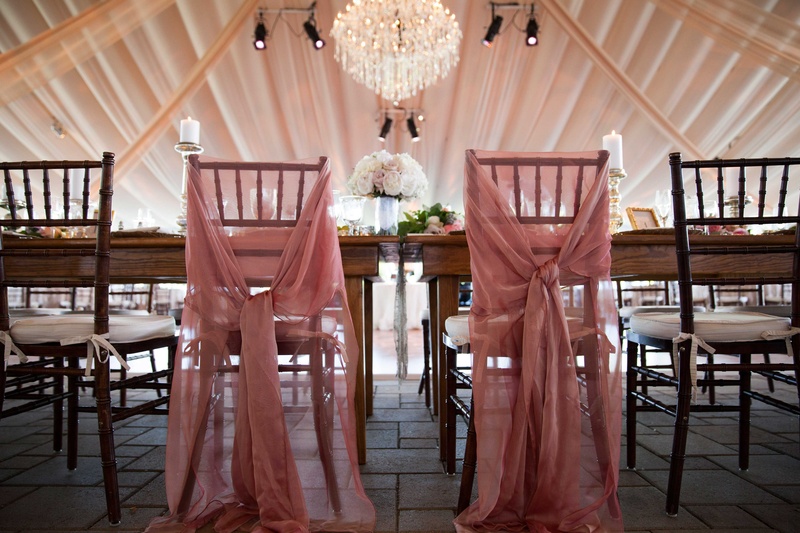 Pink Fabric Around Bride and Groom Chairs
Photography: Michael Bambino %26 Co.
Read More:
http://www.insideweddings.com/weddings/whimsical-open-air-secret-garden-wedding-with-soft-spring-hues/777/ sheer pink fabric tied around the reception chairs for both the bride and the groom