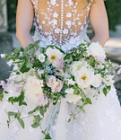 Gorgeous White, Pink %26 Blue Bouquet
Photography: Dear Stacey
Read More:
http://www.insideweddings.com/weddings/sentimental-alfresco-ceremony-classic-reception-at-oheka-castle/1016/ Back of Angel Sanchez wedding dress buttons flower applique vines and loose bouquet greenery